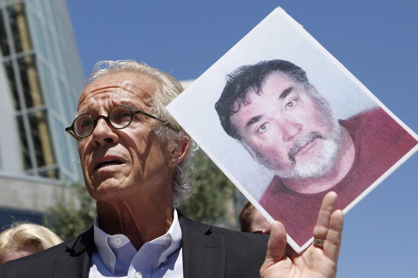 FILE - Attorney Jeff Anderson holds up a photo of former priest Stephen Kiesle at a news conference in Oakland, Calif., Wednesday, Aug. 18, 2010. The family of the late Jim Bartko, who said he was molested as a child by Kiesle, has filed a lawsuit against the Roman Catholic church under a new California law that allows family members of sex abuse victims to bring lawsuits after their deaths. The family of Bartko filed the suit in January 2022 in Alameda County Superior Court against the Diocese of Oakland. (AP Photo/Jeff Chiu, File)