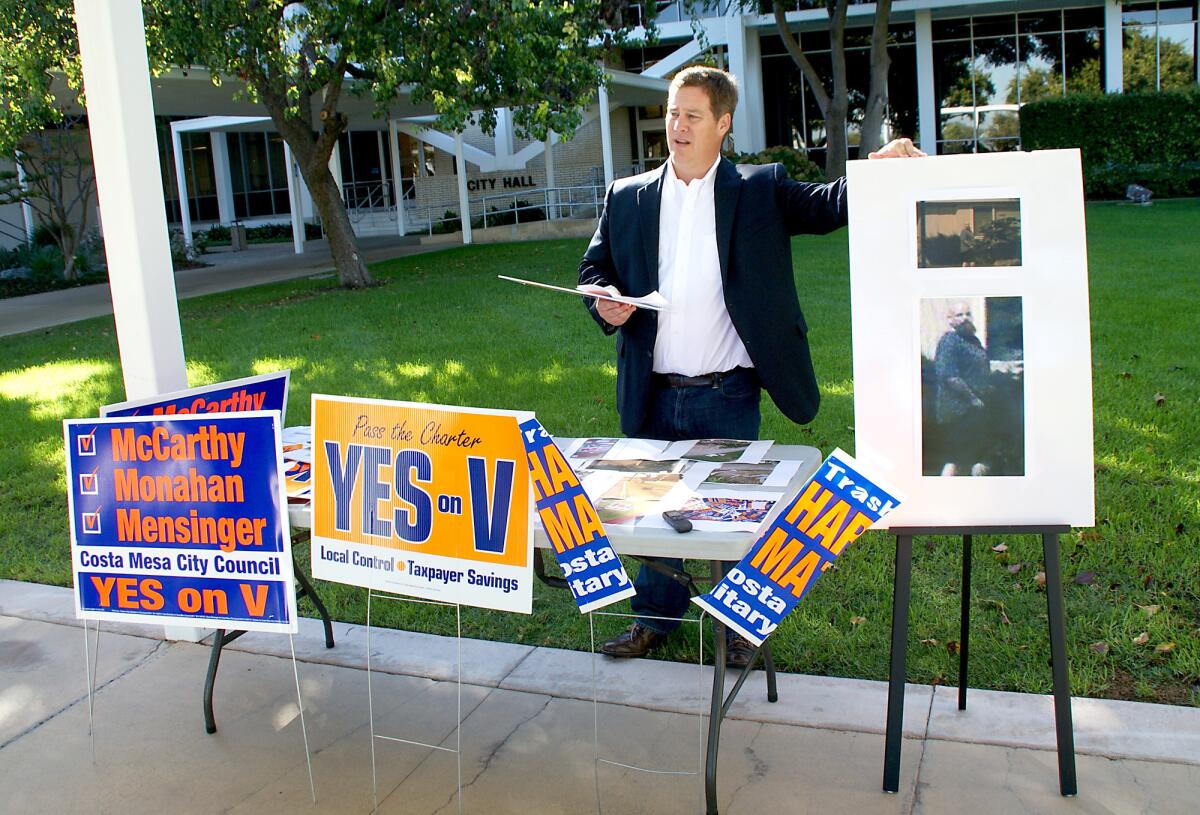 Jim Fitzpatrick stands in front of Costa Mesa City Hall in 2012 to talk about political signs that were destroyed throughout the city.