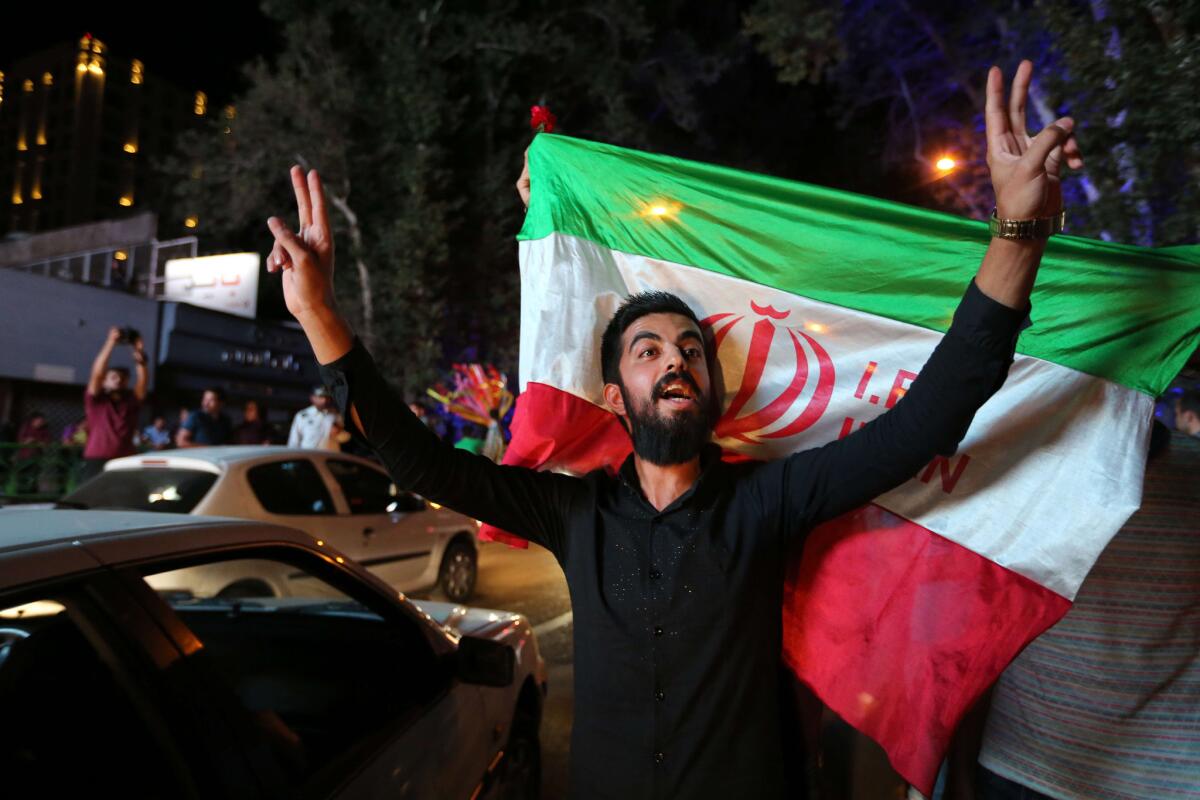 An Iranian man celebrates last month in Tehran after Iran's nuclear negotiating team struck a deal with world powers in Vienna.