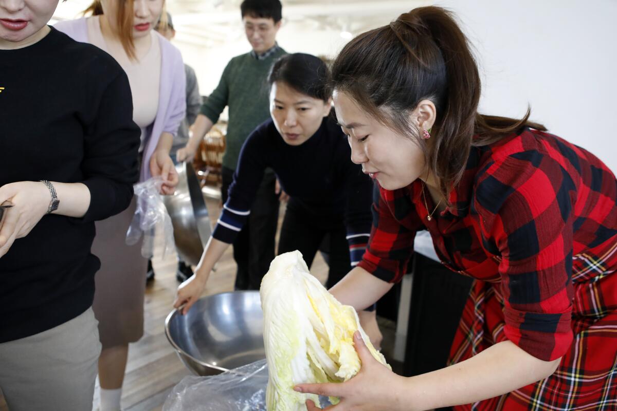 Jessie Kim prepares nappa cabbage marinated in salt water as she teaches North Korean-style kimchi at  her cooking class in Seoul.