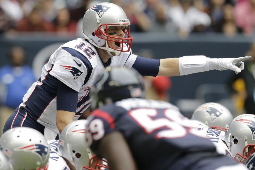 New England Patriots quarterback Tom Brady signals during a game against the Houston Texans in Houston on Dec. 1, 2013.