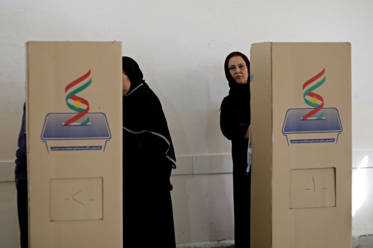 FILE - In this Sept. 30, 2018 file photo, Iraqi Kurdish women cast their ballots during parliamentary elections in Irbil, Iraq. With the help of the United Nations, authorities in Iraq are taking measures to prevent voter fraud in national elections in October 2021. The U.N. envoy to Iraq Jeanine Hennis-Plasschaert stressed on Tuesday, Sept. 7, 2021 while speaking to reporters in Baghdad, that Iraqi political parties and candidates must abstain from intimidation, voter suppression and bribes to ensure the federal elections are free and fair. (AP Photo/Salar Salim, File)