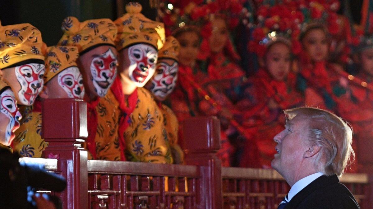 President Trump talks to opera performers Nov. 8 at the Forbidden City in Beijing, part of a tour with Chinese leader Xi Jinping that opened the China leg of his trip to Asia.
