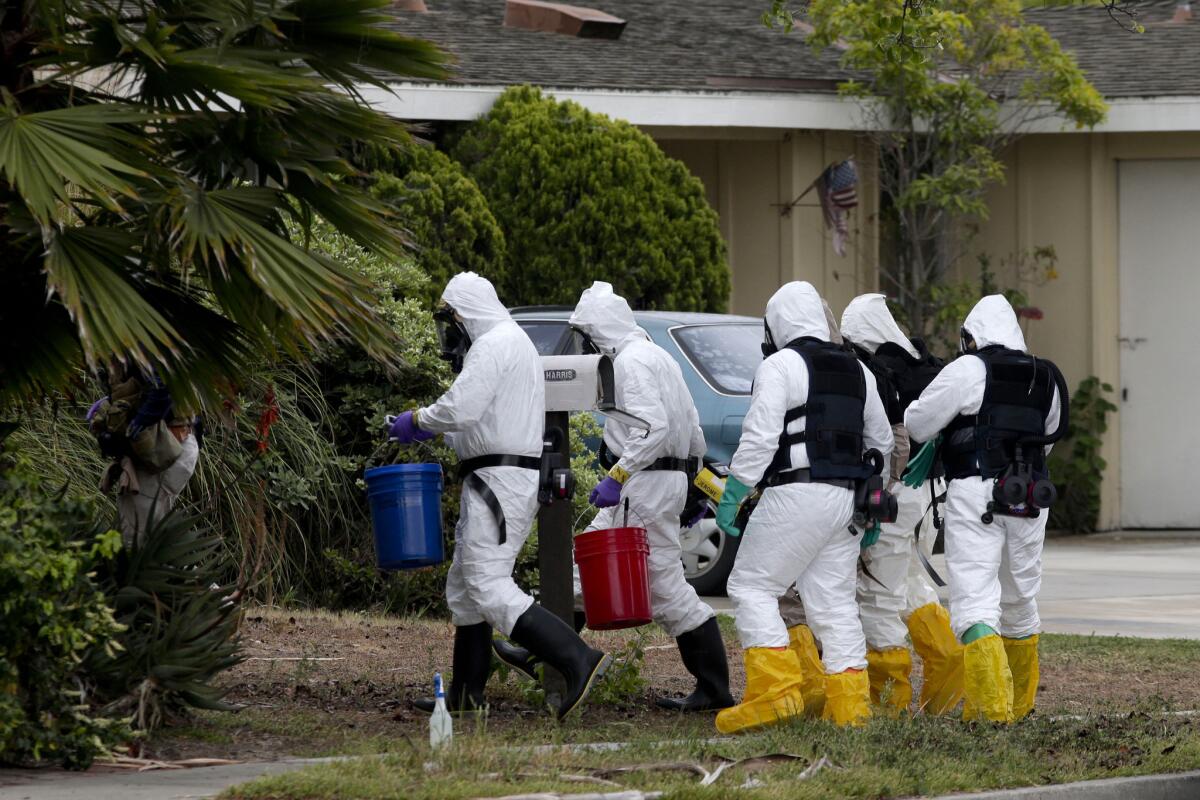 A group of investigators enter a home in Costa Mesa where a man died in an explosion.