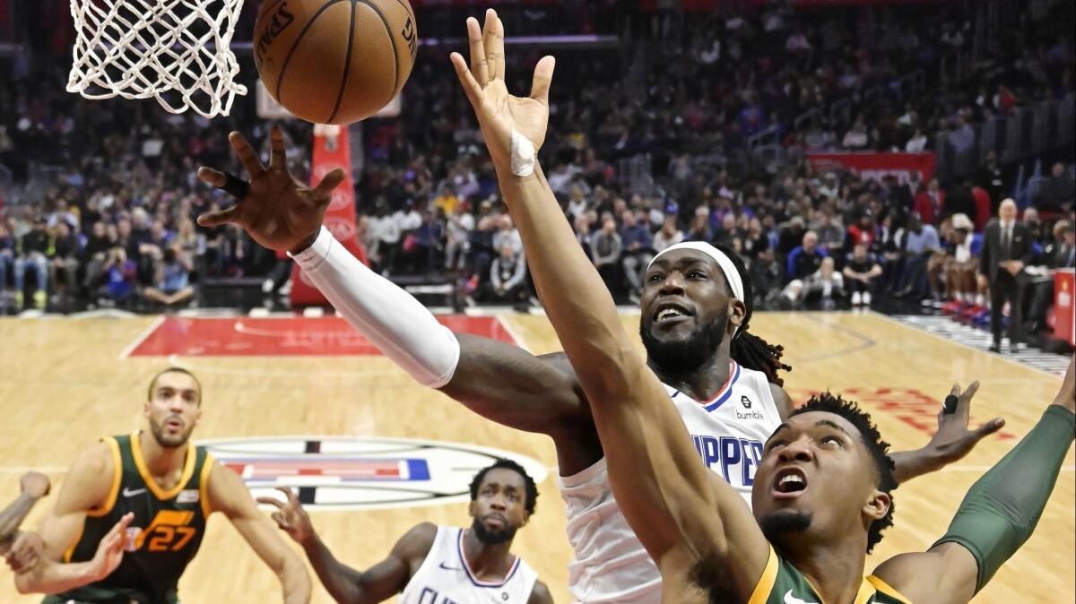 The Clippers' Montrezl Harrell defends as Utah's Donovan Mitchell shoots during Wednesday's game.