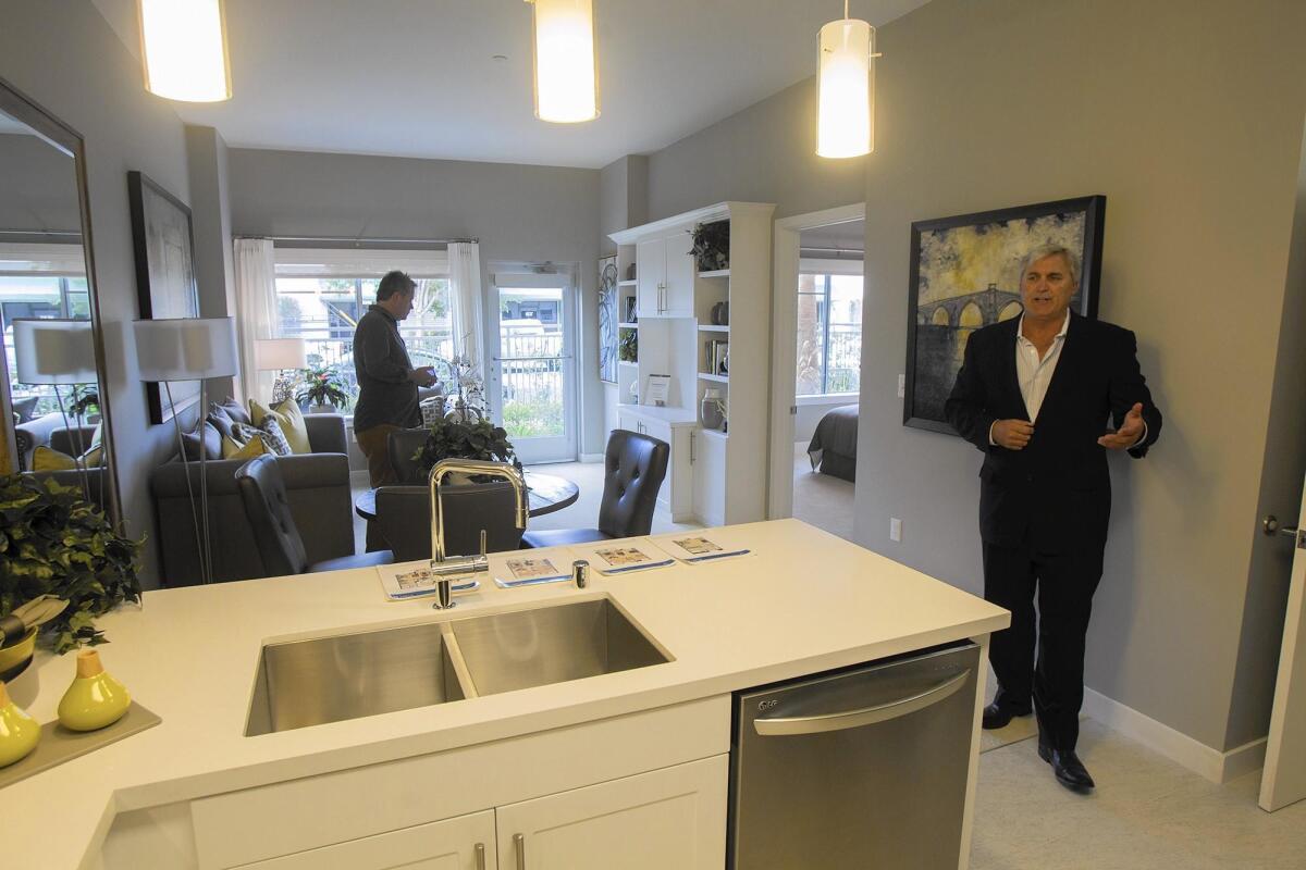 Cory Alder, president of Nexus Development Corp., shows a one-bedroom unit at Vivante on the Coast, a senior-living community in Costa Mesa, in 2013. Nexus won Planning Commission approval Monday to expand Vivante by 111 units.