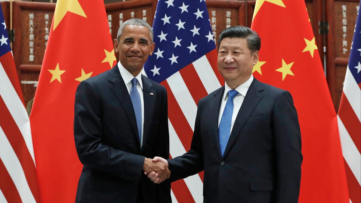 Chinese President Xi Jinping greets President Barack Obama before their meeting in Hangzhou.