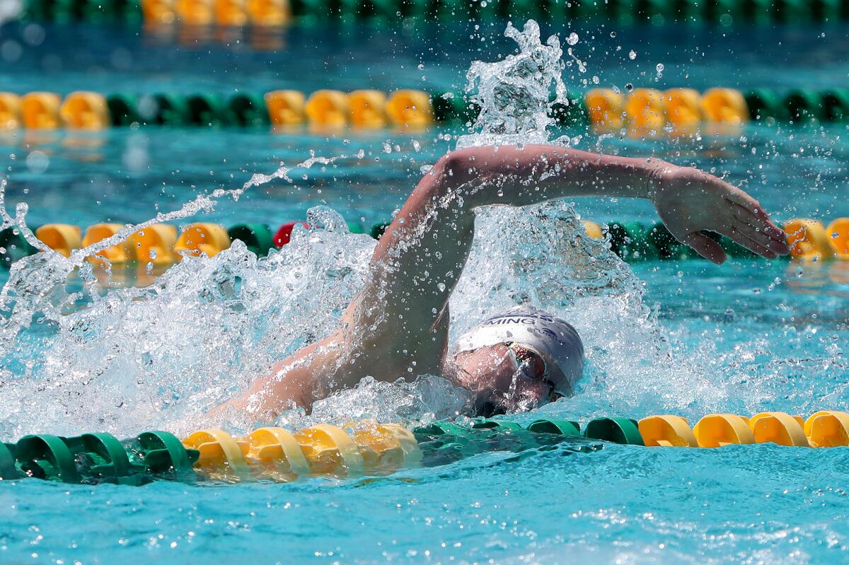 Newport Harbor junior Finn Genc competes in the boys' 200 freestyle during the Surf League swim finals Friday.