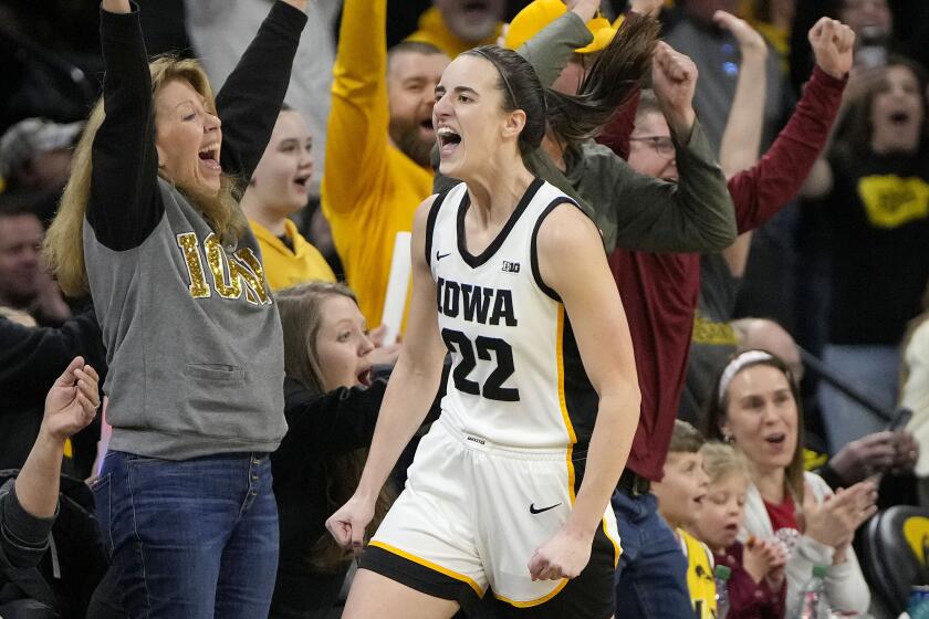 Iowa guard Caitlin Clark (22) reacts after breaking the NCAA women's career scoring record.