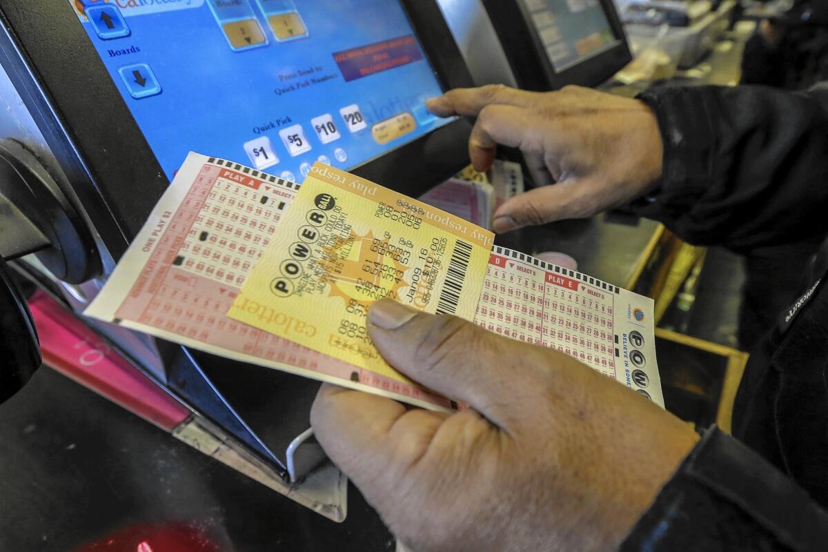 People buy Powerball lottery tickets at the Bluebird liquor store in Hawthorne.