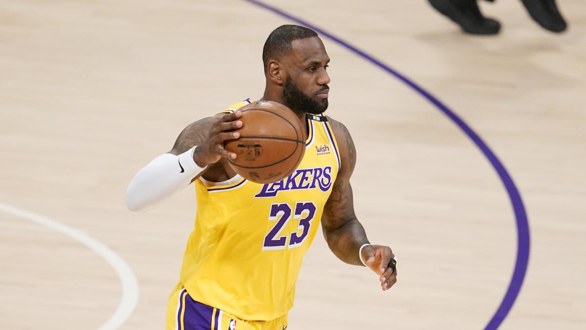 Lakers star LeBron James dribbles the ball during a game.