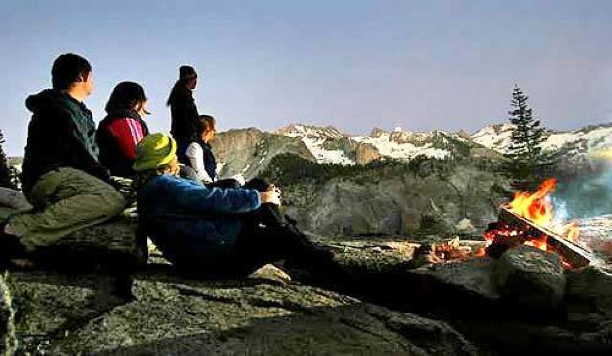 Bearpaw Meadow High Sierra Camp guests enjoy a warm campfire.