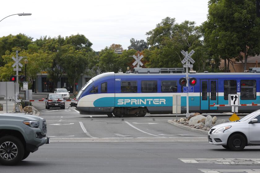 Vista, CA - December 19: The Sprinter crosses Main Street in Vista on Tuesday, December 19, 2023. (K.C. Alfred / The San Diego Union-Tribune)