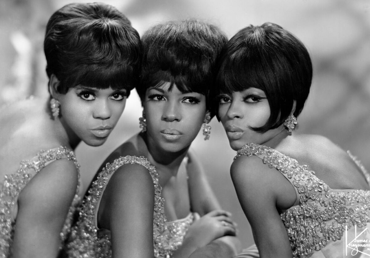 The Supremes dressed in matching sequined gowns.