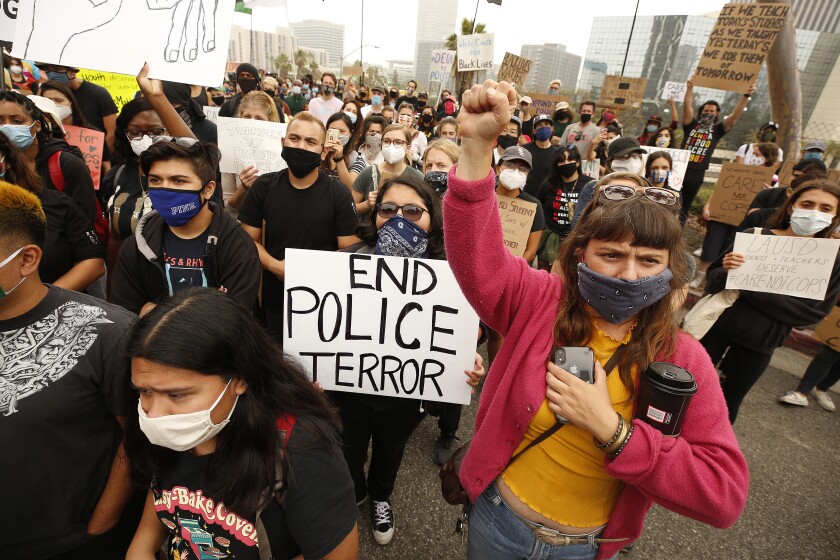 LOS ANGELES, CA - JUNE 23: Jesika Lee Foster, right, a LAUSD parent joins members of Black Lives Matter-Los Angeles and their supporters as they hold a demonstration outside LAUSD headquarters during the School Board Zoom meeting to demand that the Board of Education defund school police, reallocating funds to other student-serving initiatives. Los Angeles on Tuesday, June 23, 2020 in Los Angeles, CA. (Al Seib / Los Angeles Times)