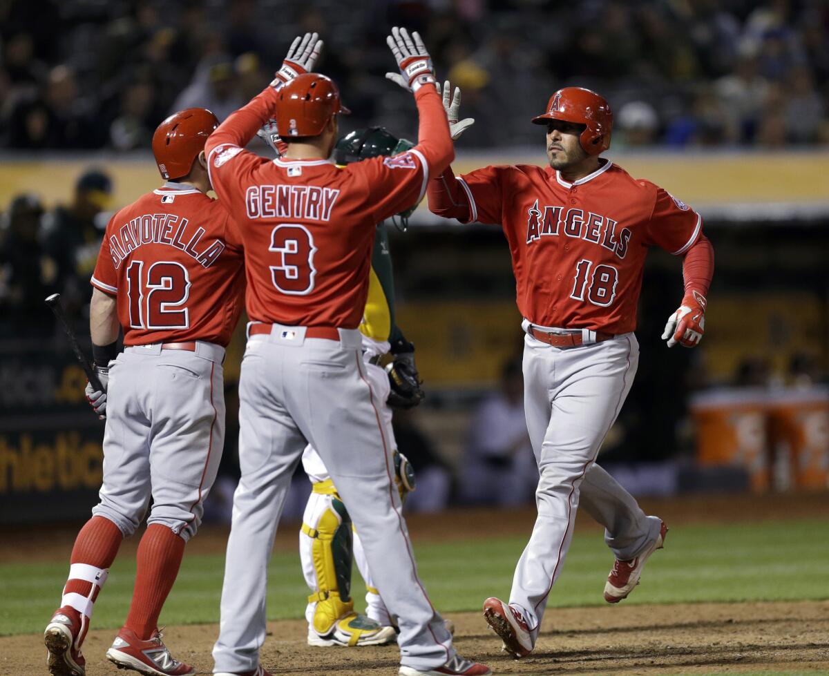 Geovany Soto is congratulated by Johnny Giavotella (12) and Craig Gentry (3) after hitting a two-run home run in the ninth inning of the Angels' 5-4 win over the Athletics on April 12.