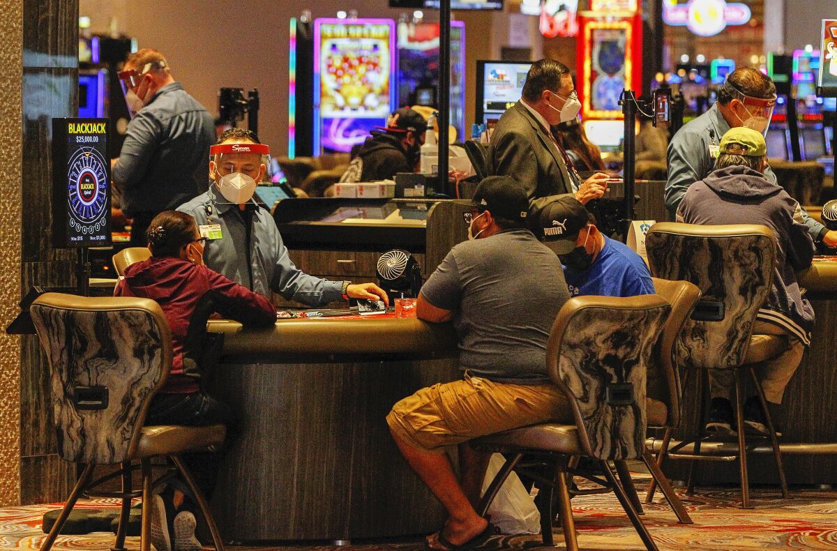 Patrons play blackjack on opening day at the Sycuan Casino on May 20, 2020 in El Cajon, California.