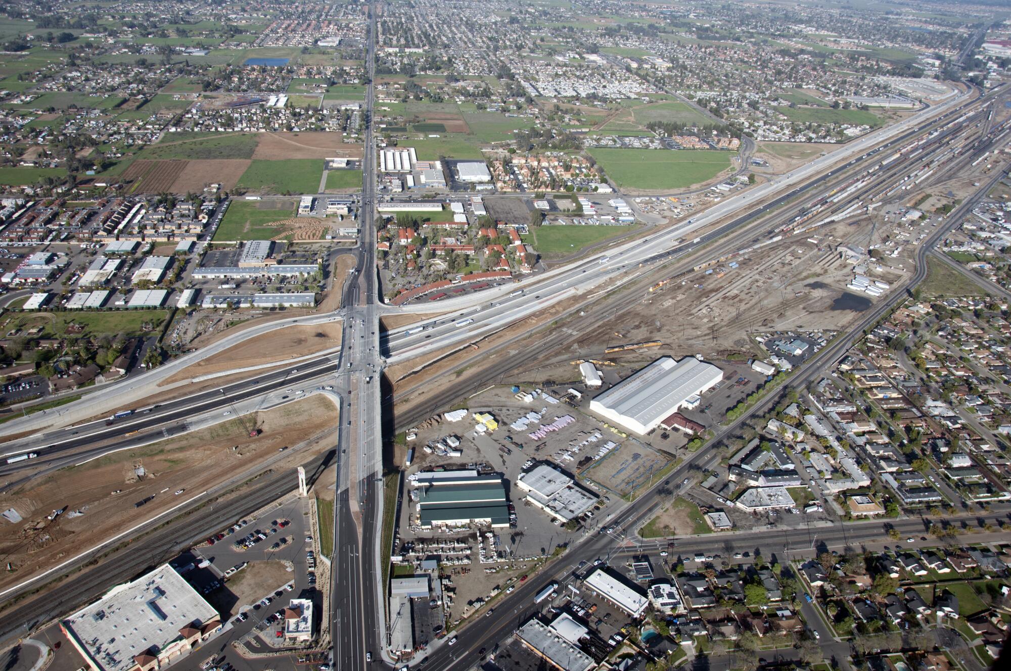 Aerial view of a highway realignment project surrounded by residential and commercial areas