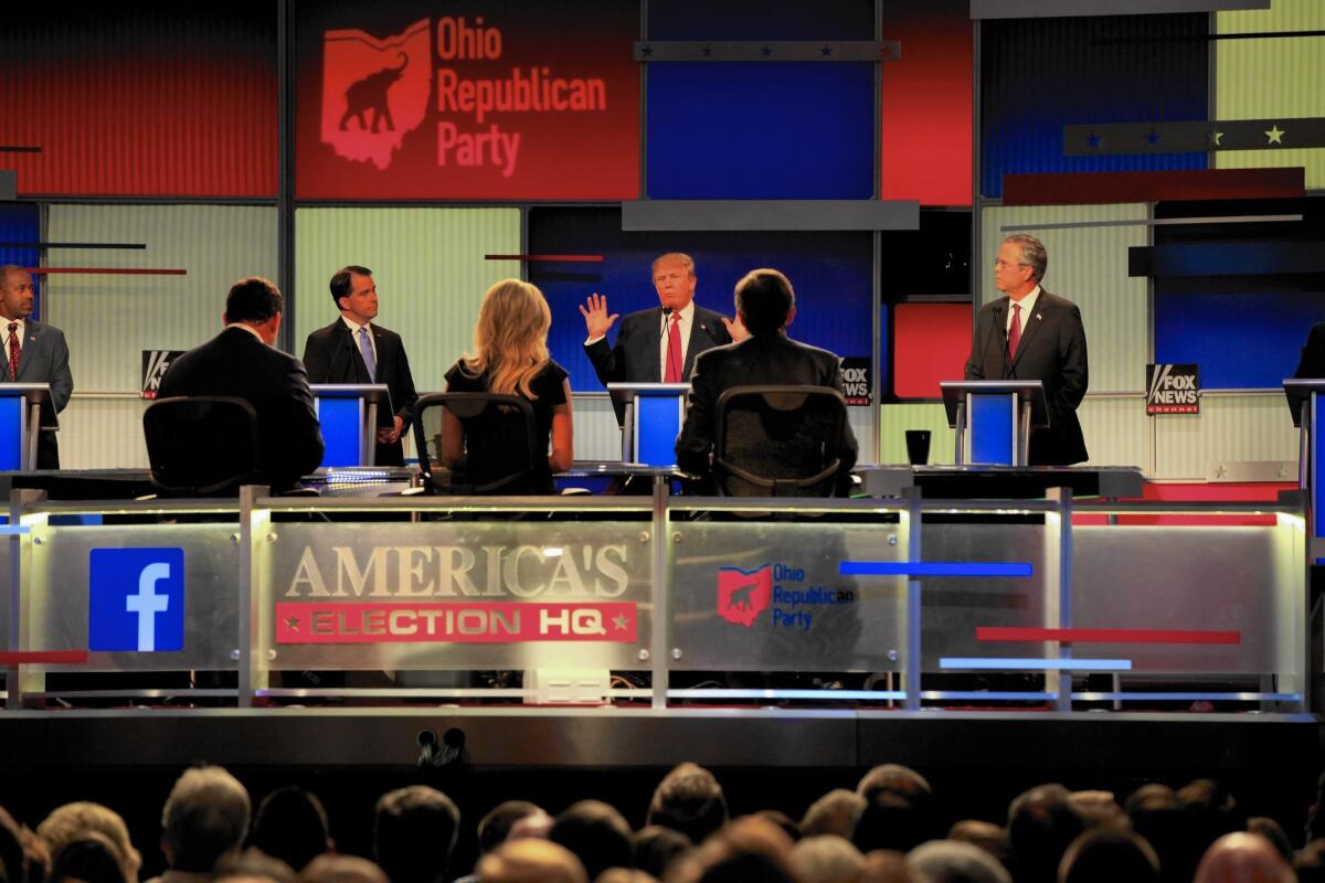 Donald Trump, center, speaks during the Republican presidential debate Thursday in Cleveland.