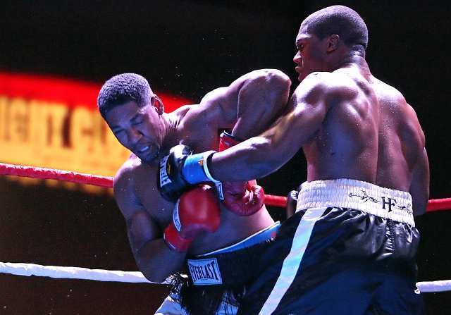 Heavyweight Quadtrine Hill, right, lands a left on the chin of Chad Davis at the Fight Club OC in the Hangar at the Orange County Fairgrounds and Event Center.