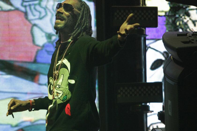 Snoop Dogg, a.k.a. Snoopzilla, looks funky but chic in his Pepe Le Pew sweat shirt during the record release concert for '7 Days of Funk' at the Exchange Los Angeles on Dec. 10.