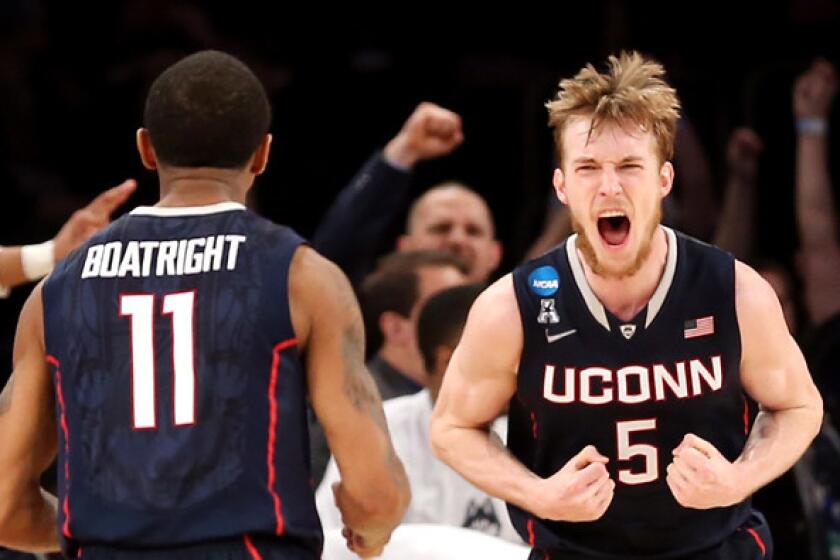 Connecticut forward Niels Giffey (5) reacts along with teammate Ryan Boatright after making a shot against Iowa State during an NCAA tournament East Regional semifinal on Friday night in New York.