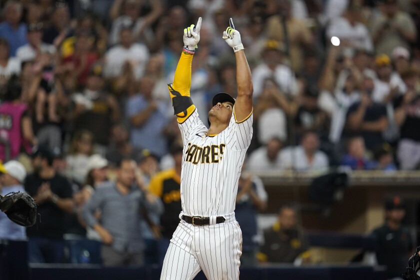 San Diego Padres' Juan Soto points two fingers and looks upward after hitting a home run