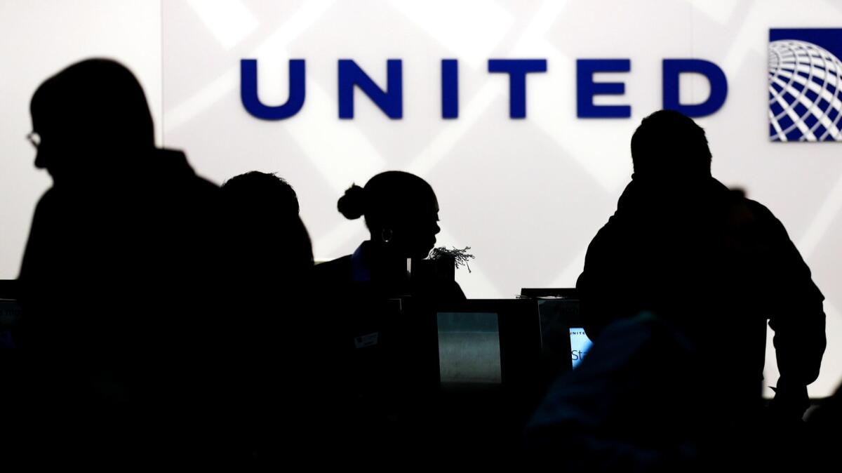 Travelers check in at the United Airlines ticket counter at Terminal 1 in O'Hare International Airport in Chicago on Dec. 21, 2013.