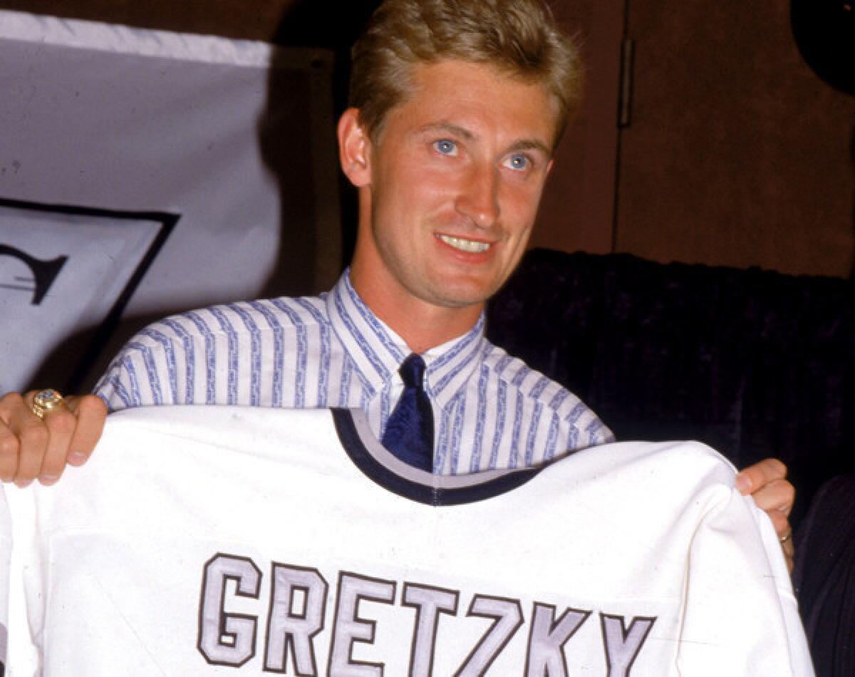 Wayne Gretzky shows off his new Kings uniform during a news conference after the trade.