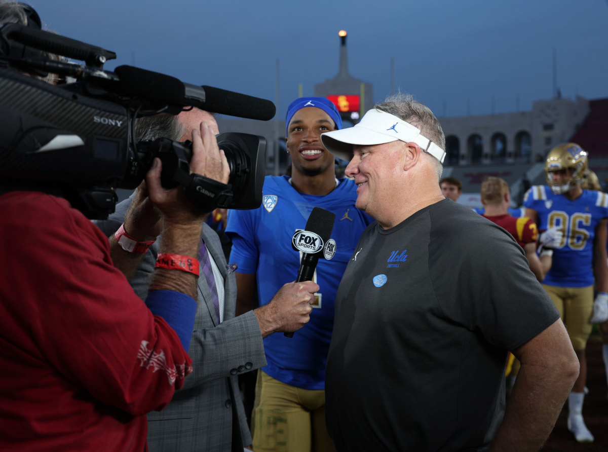 UCLA quarterback Dorian Thompson-Robinson and coach Chip Kelly are interviewed by a Fox sideline reporter.