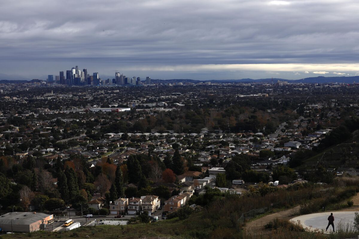 A storm passes over the downtown Los Angeles skyline, as seen from the Baldwin Hills Scenic Overlook in Culver City.
