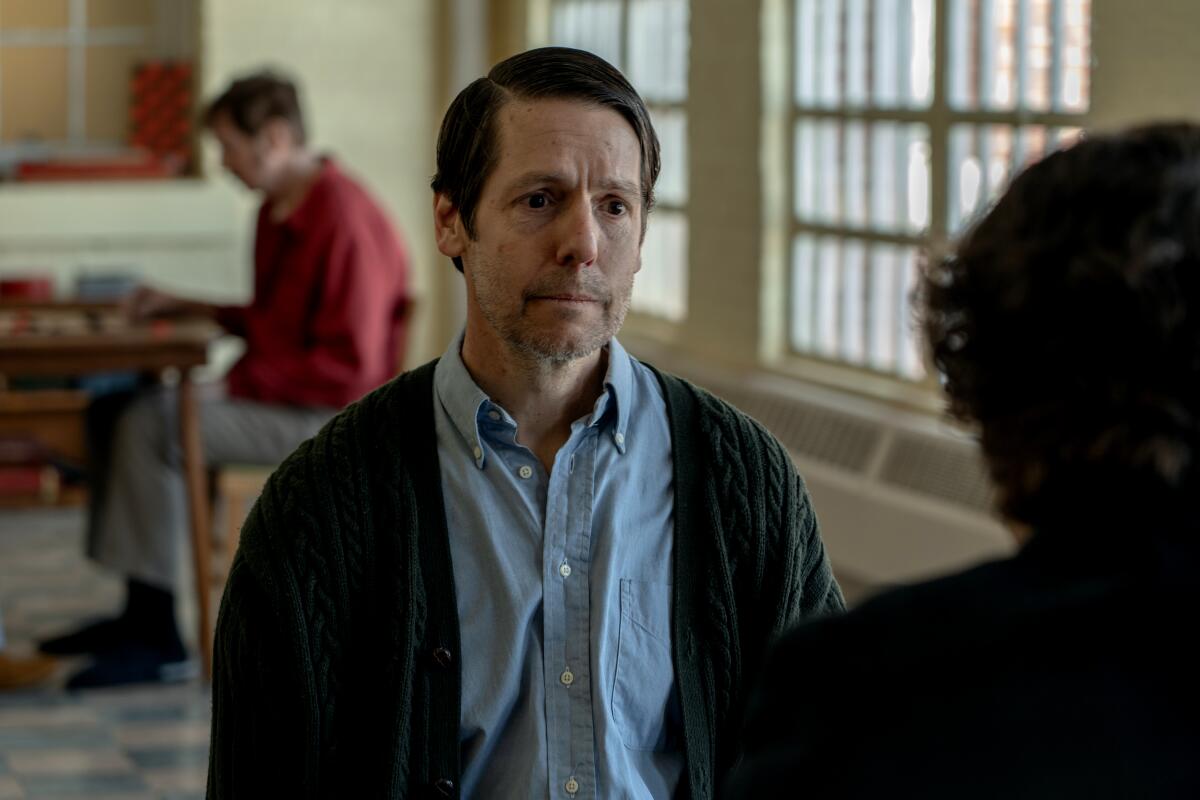 A man in a mental institution talks with his son in a scene from "The Holdovers."
