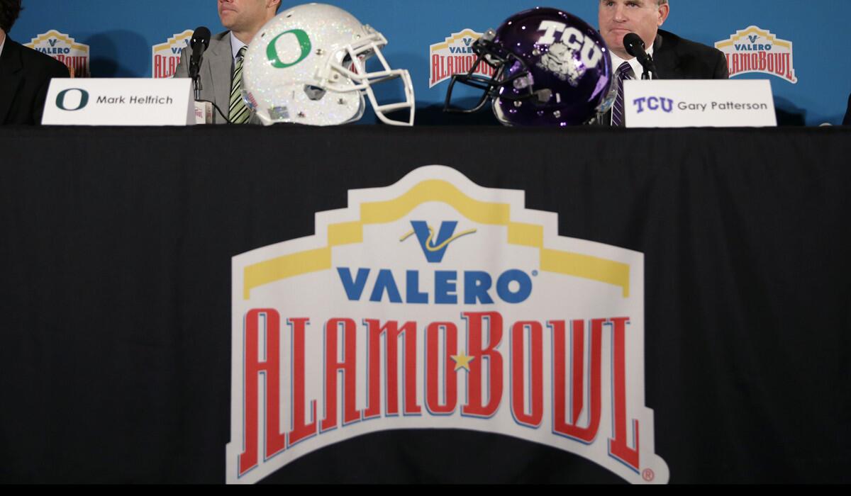 Helmets from Oregon and TCU are displayed during a news conference for the Alamo Bowl on Dec. 10.