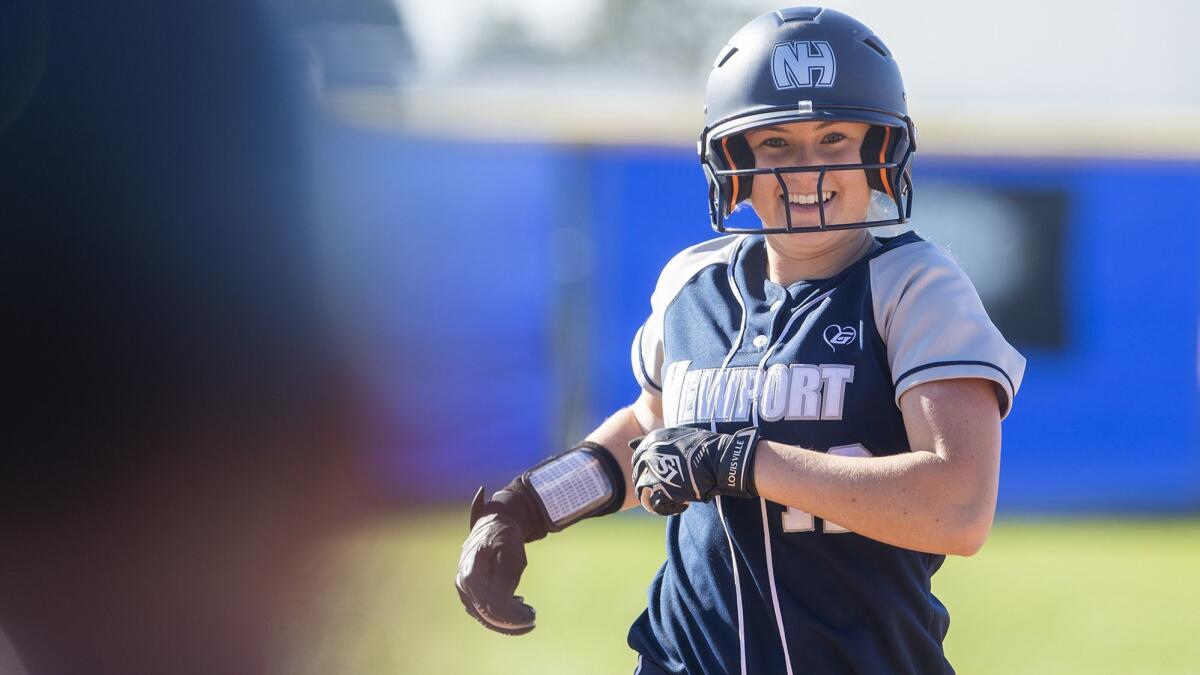 Eliana Gottlieb, shown smiling after hitting a home run on March 14, was three for three with a triple Tuesday as the Newport Harbor High softball team shut out Laguna Beach to clinch the Wave League title.
