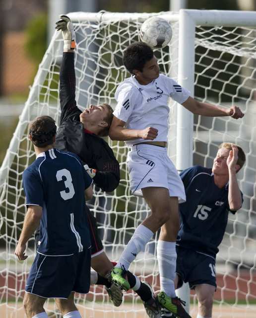 Corona del Mar's Connor Gaal goes up for a ball against Paramount's Ricardo Zavala during a CIF Southern Section Division III semifinal game at Paramount High.