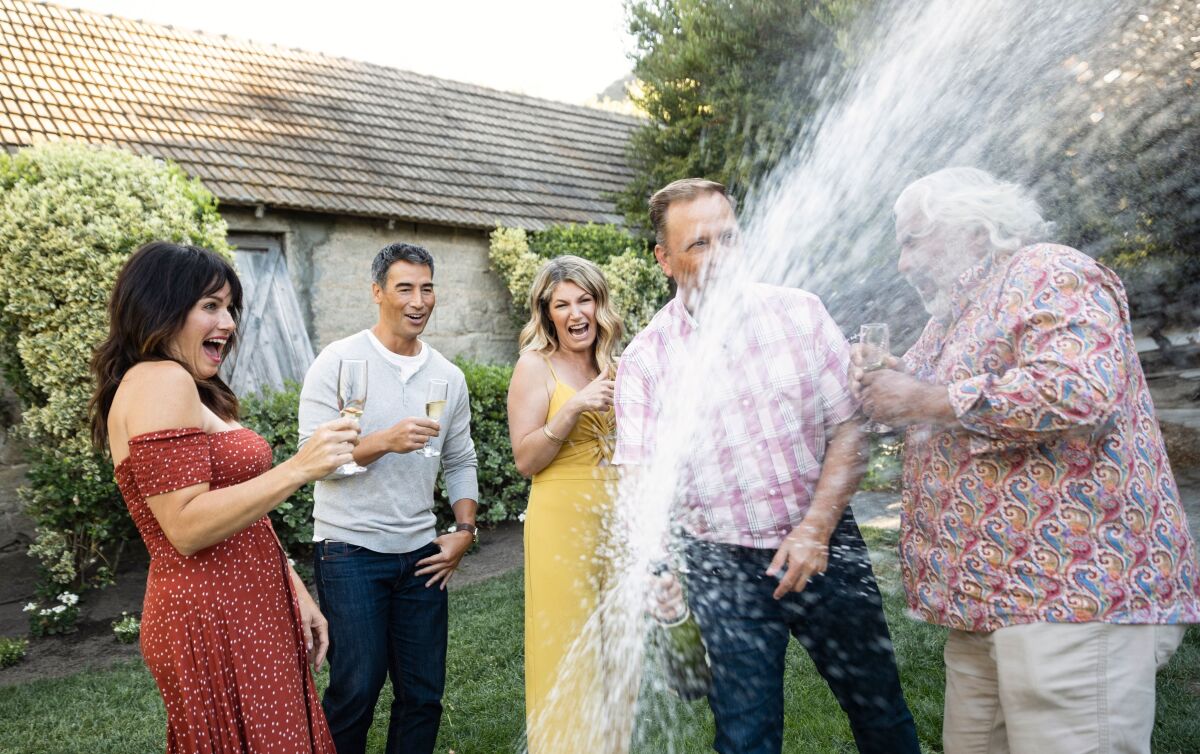 BJ Fazeli, of Fazeli Cellars, gets a shower as Jeff Carter opens sparkling wine to toast Temecula's Live Glass Full campaign.