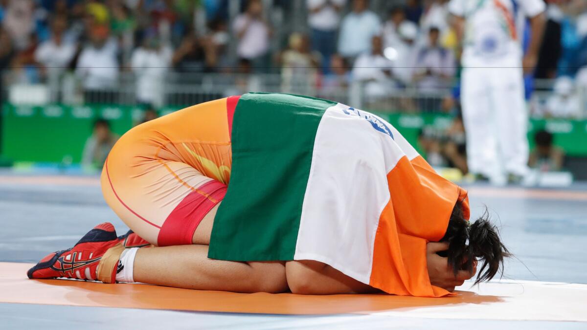 India's Sakshi Malik celebrates after winning against Kyrgyzstan's Aisuluu Tynybekova in their women's 58-kilogram freestyle bronze medal match Aug. 17 during the wrestling event of the Rio 2016 Olympic Games.
