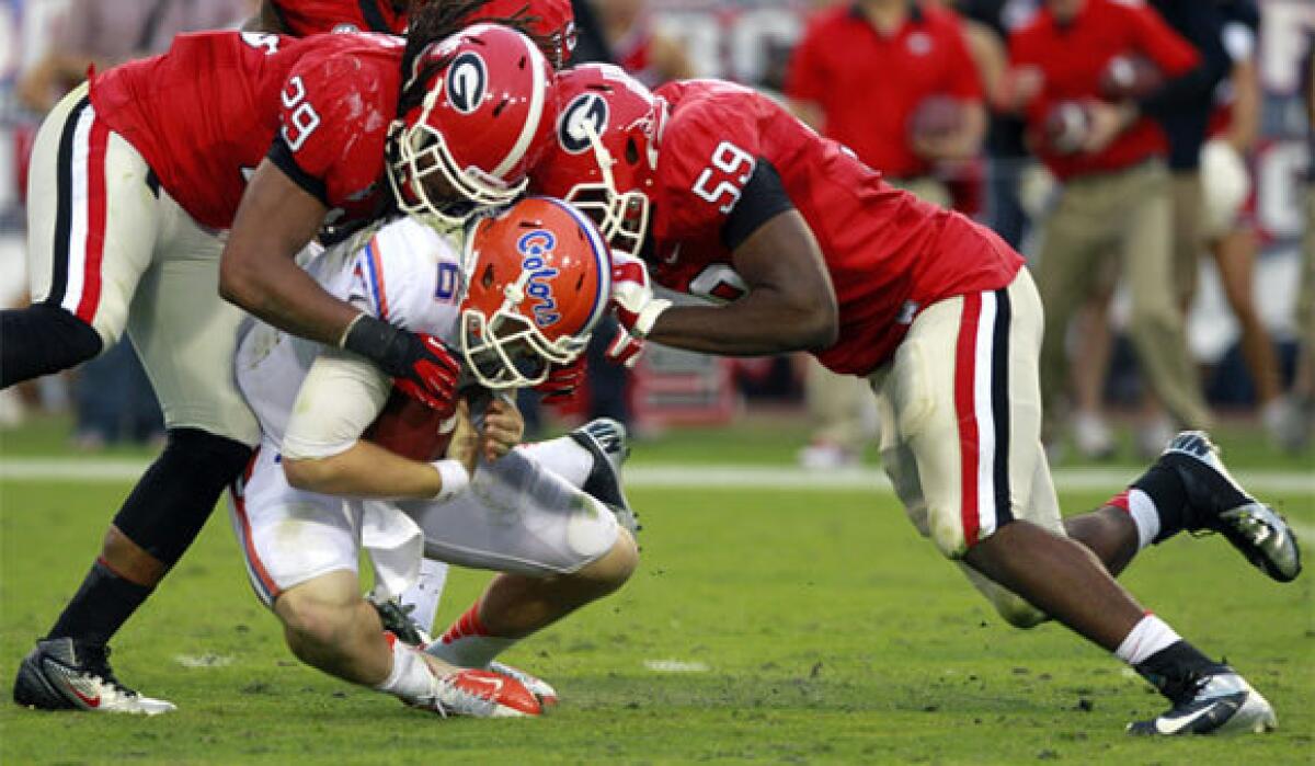 Florida quarterback Jeff Driskel is sacked for a loss by Georgia's Jarvis Jones and Jordan Jenkins back in October. Georgia won that matchup but would be left out of a four-team playoff in favor of Florida, according to a Sports Illustrated survey.