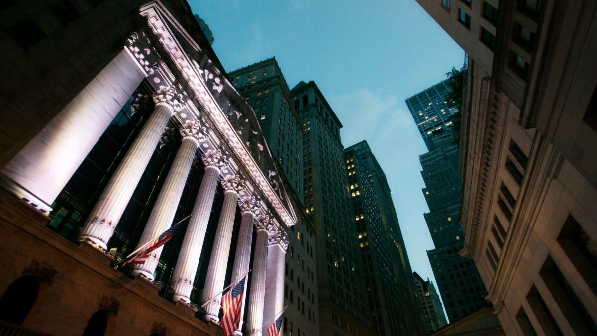 U.S. flags fly in front of the New York Stock Exchange.