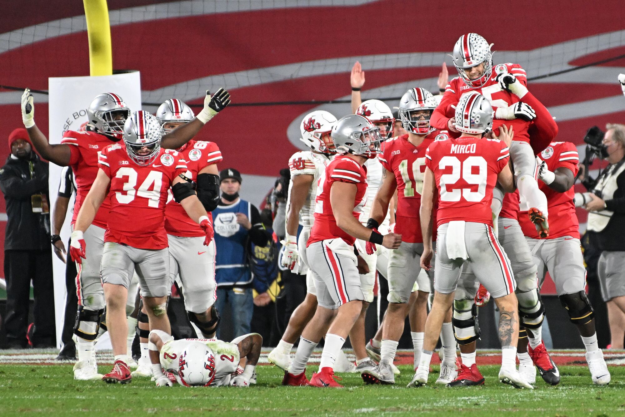 Ohio State kicker Noah Ruggles is lifted in the air after kicking the winning field goal against Utah.