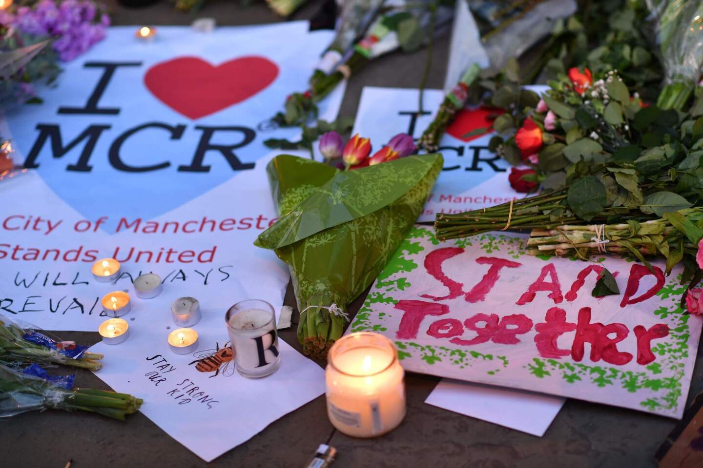 Messages of unity at Manchester's Albert Square on Tuesday, the day after the deadly attack at a pop concert.