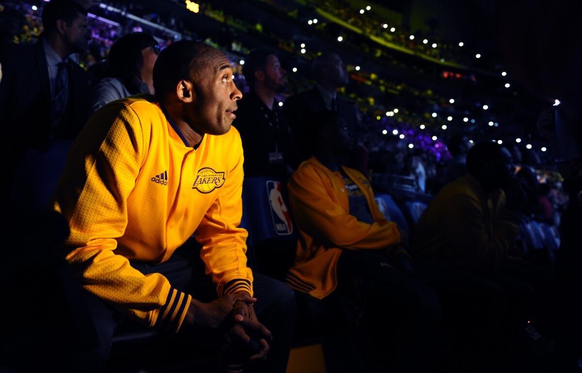 Lakers star Kobe Bryant watches a tribute video at Staples Center before the final game of his career on April 13, 2016 