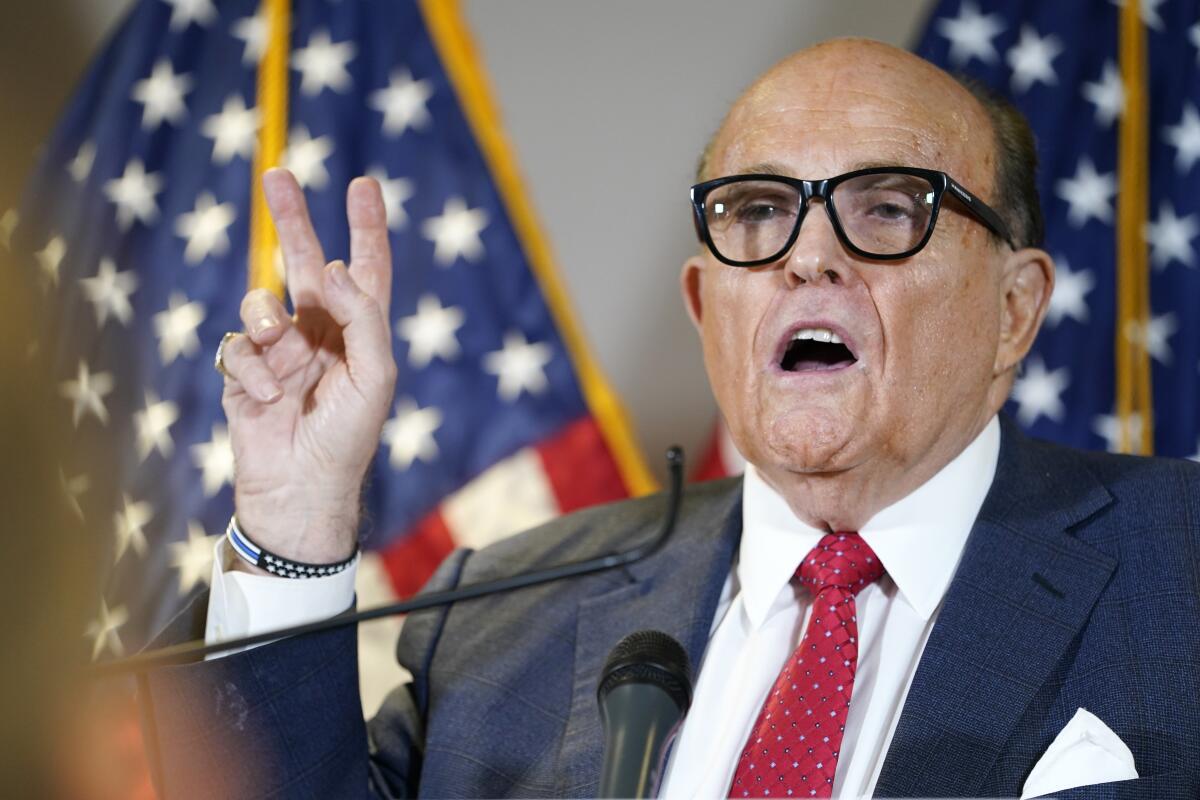 FILE - Former Mayor of New York Rudy Giuliani, a lawyer for President Donald Trump, speaks during a news conference at the Republican National Committee headquarters, Thursday Nov. 19, 2020, in Washington. President Donald Trump says his personal attorney Rudy Giuliani has tested positive for coronavirus. The president on Sunday, Dec. 6, 2020 confirmed in a tweet that Giuliani had tested positive for the virus. Giuliani has traveled extensively to battleground states in effort to help Trump subvert his election loss. (AP Photo/Jacquelyn Martin, file)