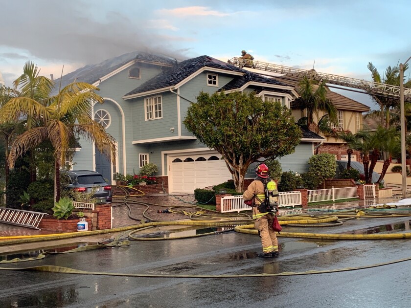 A three-alarm house fire broke out Tuesday on Huntington Harbour's Venture Drive.