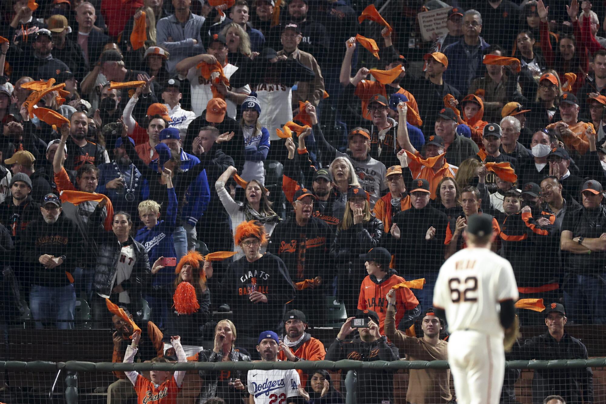 San Francisco Giants fans cheer as starting pitcher Logan Webb prepares to pitch