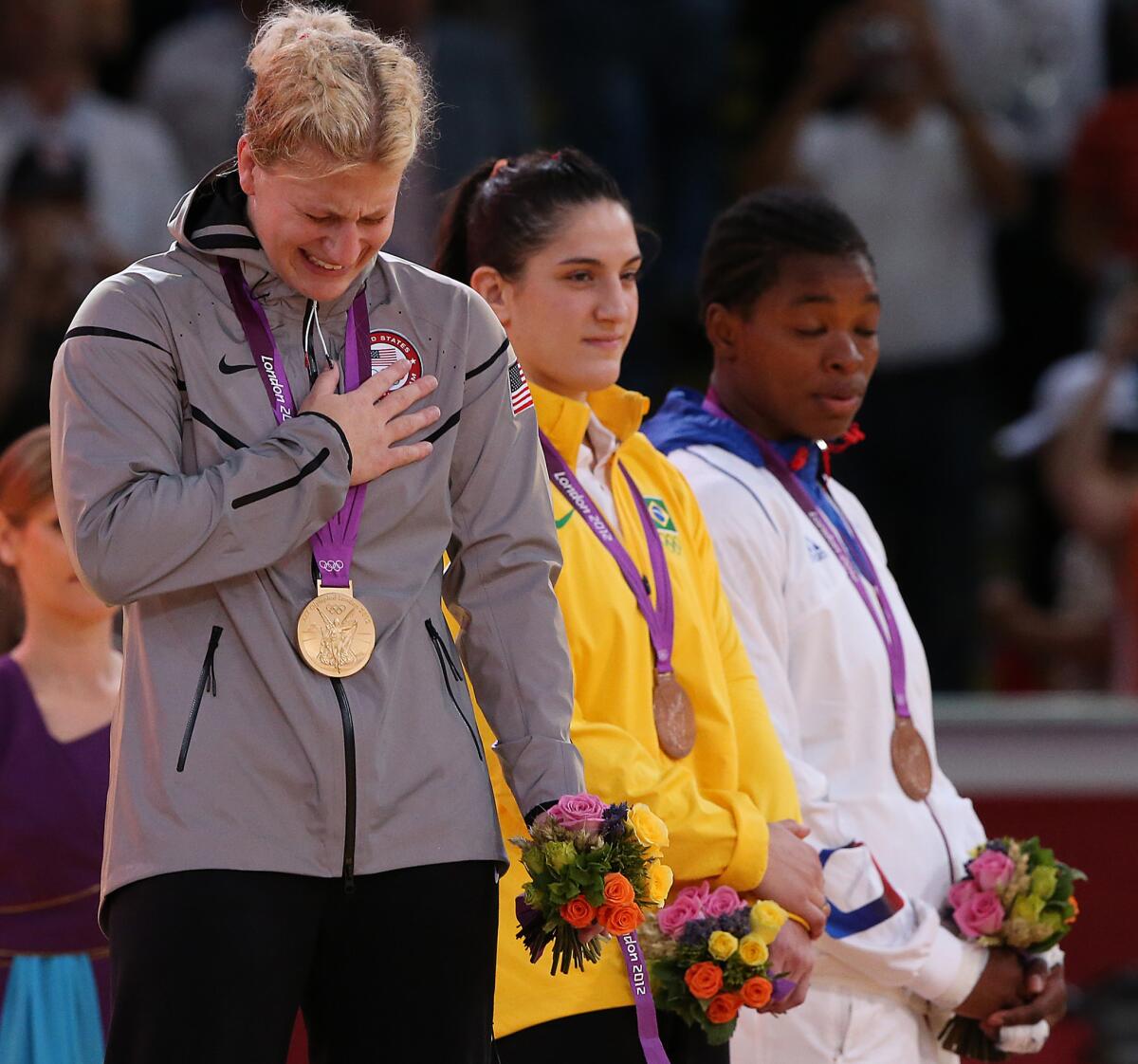 United States judo wrestler Kayla Harrison holds back tears as the national anthem plays during her gold medal ceremony at the London 2012 Olympics.