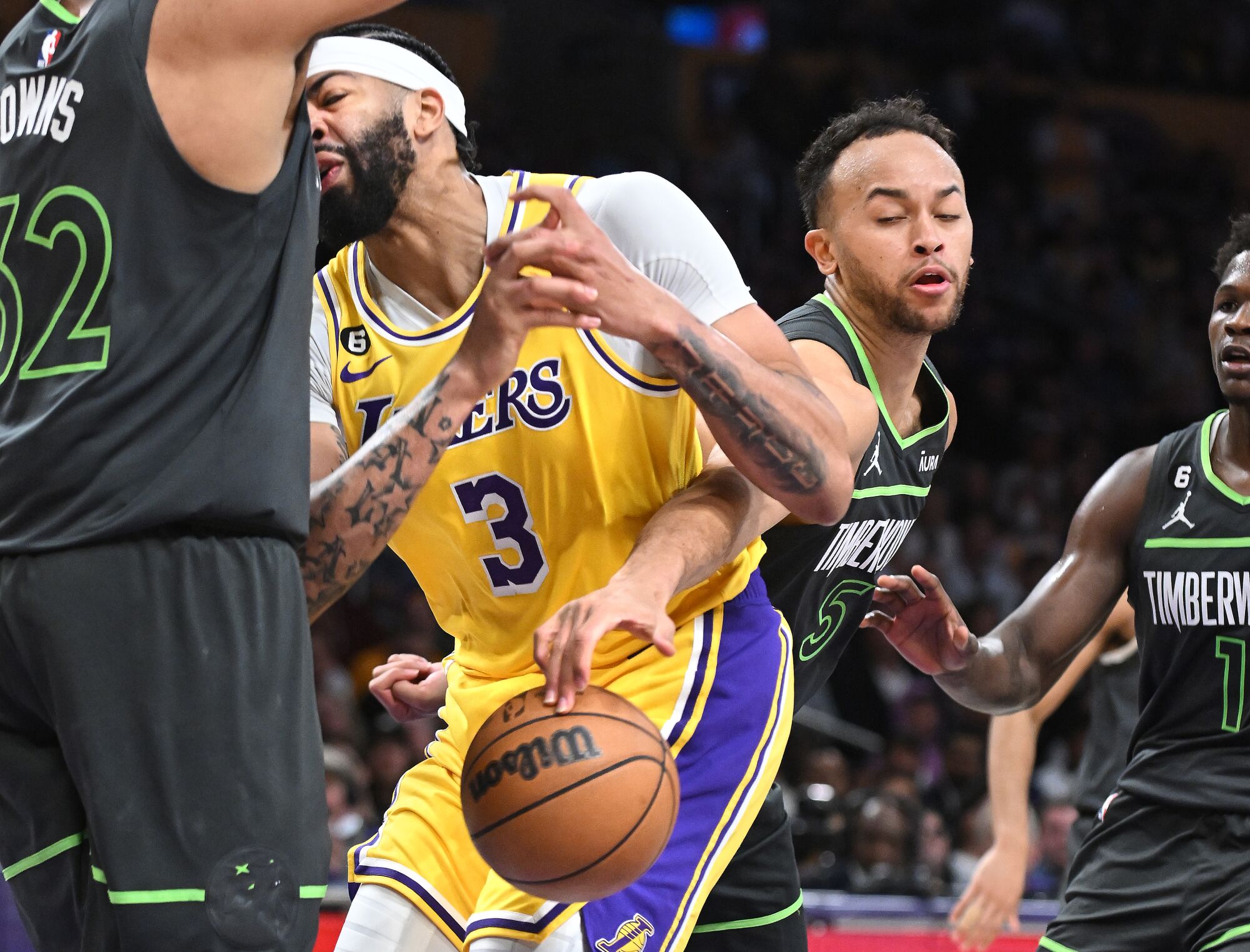 Lakers forward Anthony Davis has the ball stolen by Timberwolves forward Kyle Anderson while driving to the basket.