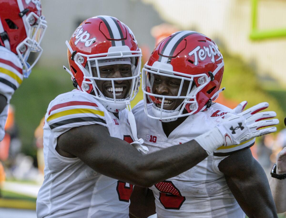 Maryland's Rakim Jarrett celebrates scoring a touchdown with teammate Chigoziem Okonkwo during the second half of an NCAA college football game against West Virginia Saturday, Sept. 4, 2021 in College Park, Md. (Kevin Richardson/The Baltimore Sun via AP)