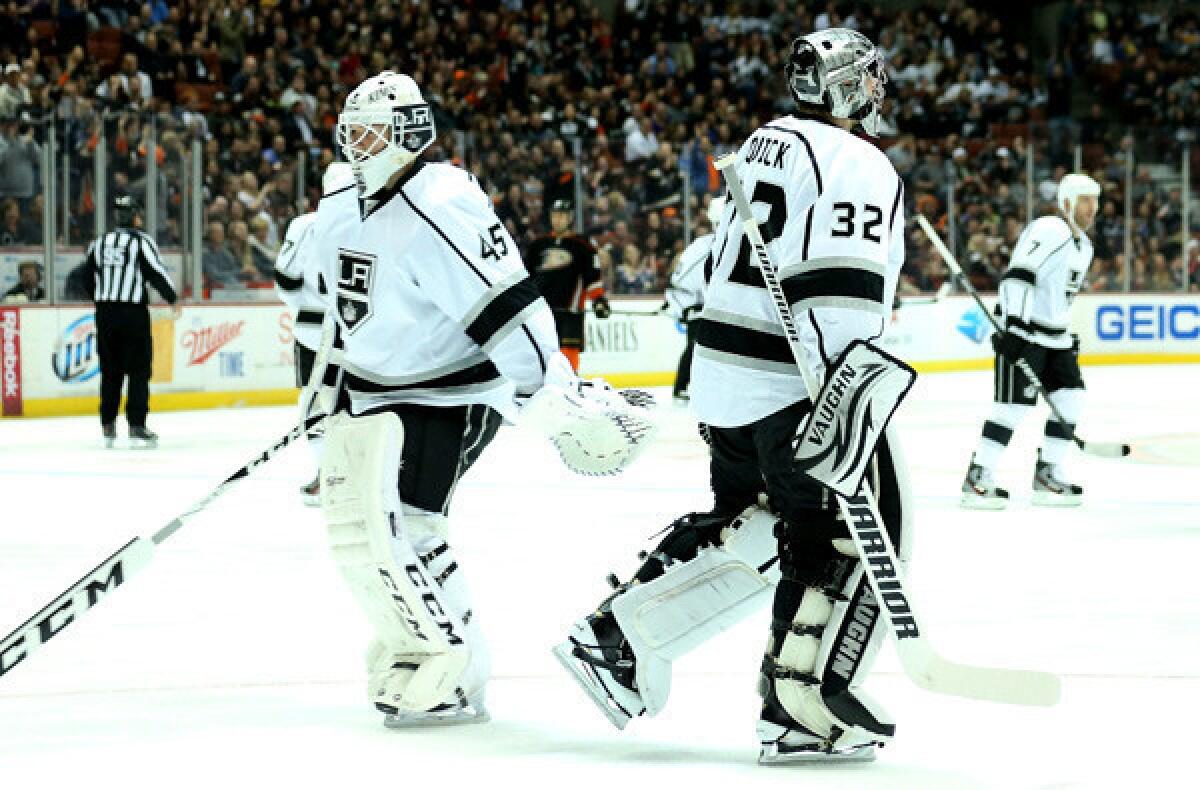 Kings goaltender Jonathan Quick (32) leaves the ice as he's replaced by Jonathan Bernier (45) in the first period Saturday night.