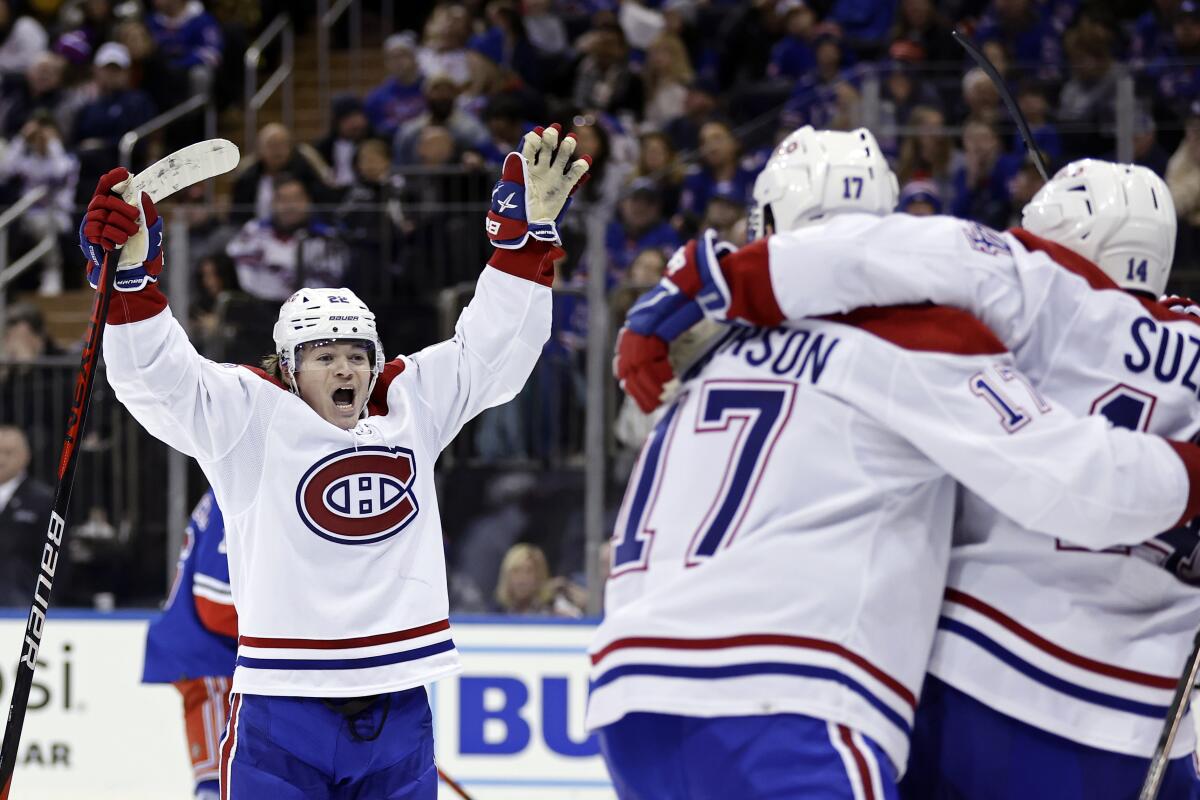 Montreal Canadiens right wing Cole Caufield, left, reacts after scoring a goal against the New York Rangers in the third period of an NHL hockey game Sunday, Jan. 15, 2023, in New York. (AP Photo/Adam Hunger)